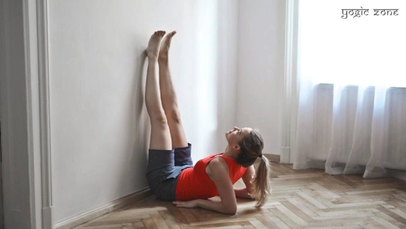 A lady in a Viparita Karani pose. Blog by yogiczone.com